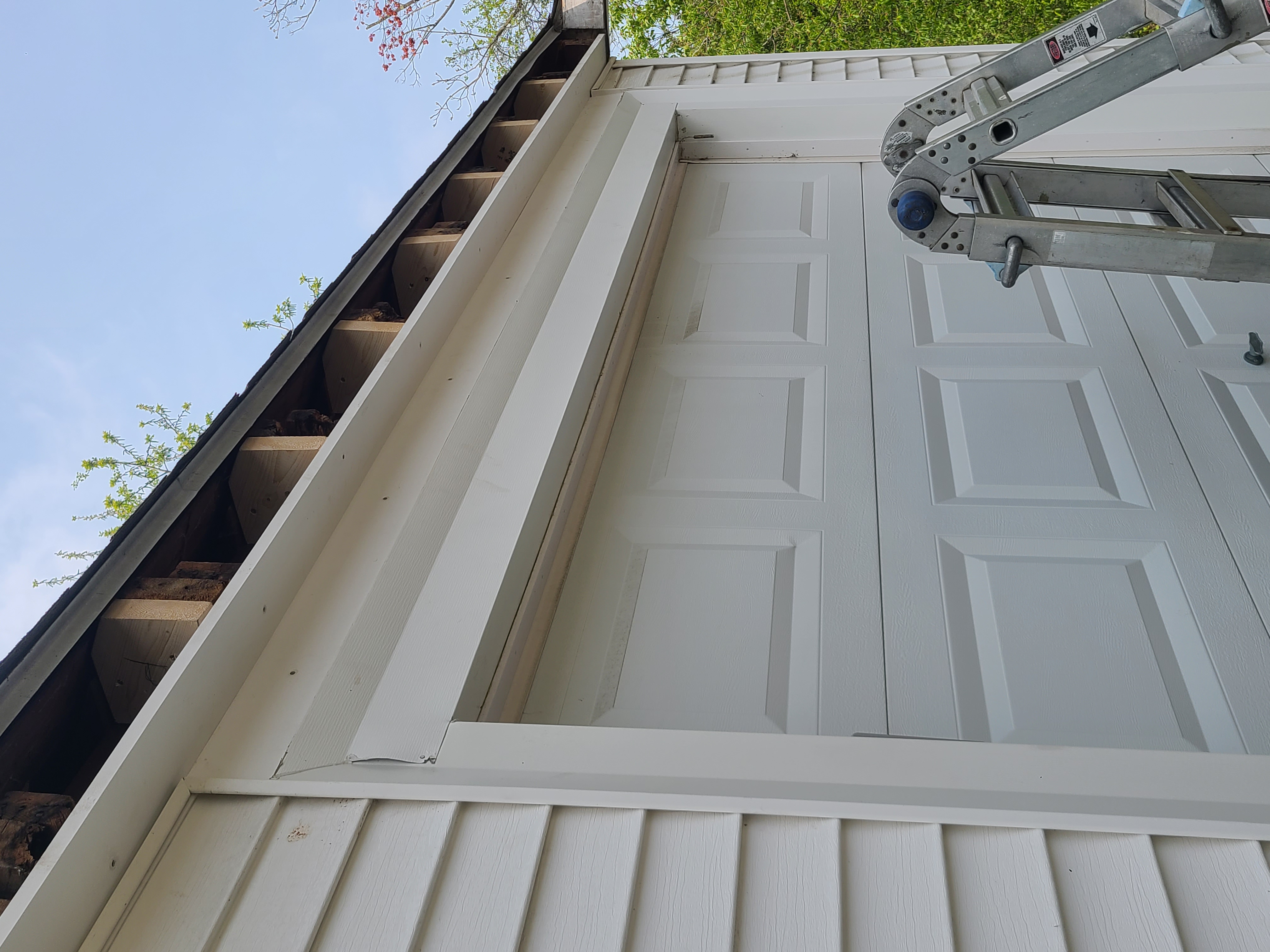 Fascia repair in progress on garage